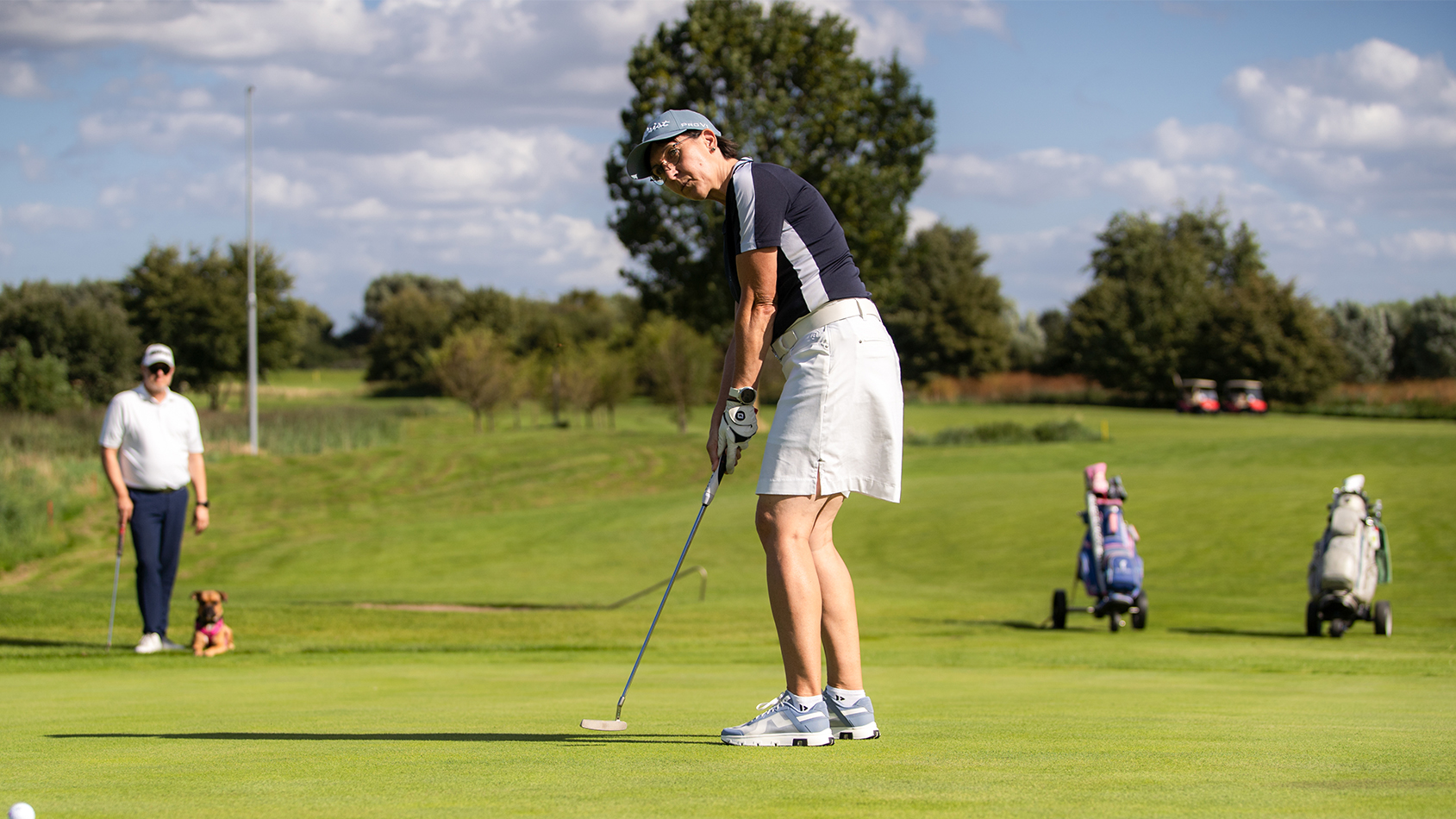 Golfschule 18 Paar mit Hund beim Putten